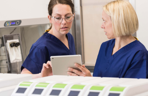 Two embryologists in the laboratory discussing fertility treatments for a patient