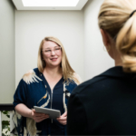 Image of a consultant talking to another woman in a hallway about infertility