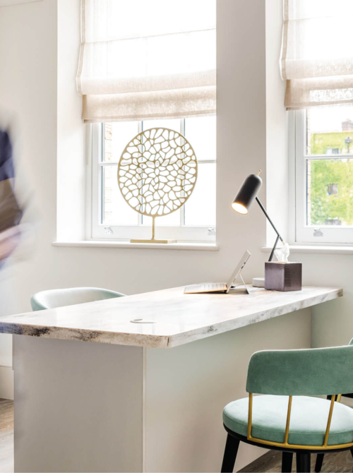 Consulting room interior showing a desk and two chairs at the Fertility Clinic